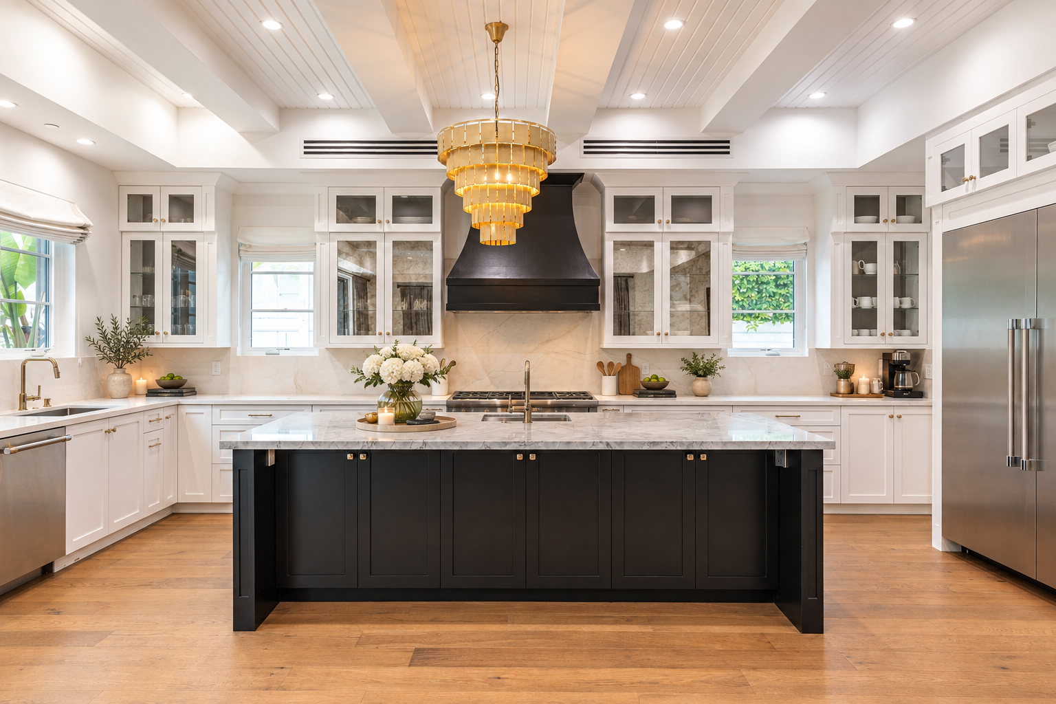 A black hood sits over the range on the back wall, while Thermador appliances, a farmhouse sink, and a large walk-in pantry complete the main cooking areas.