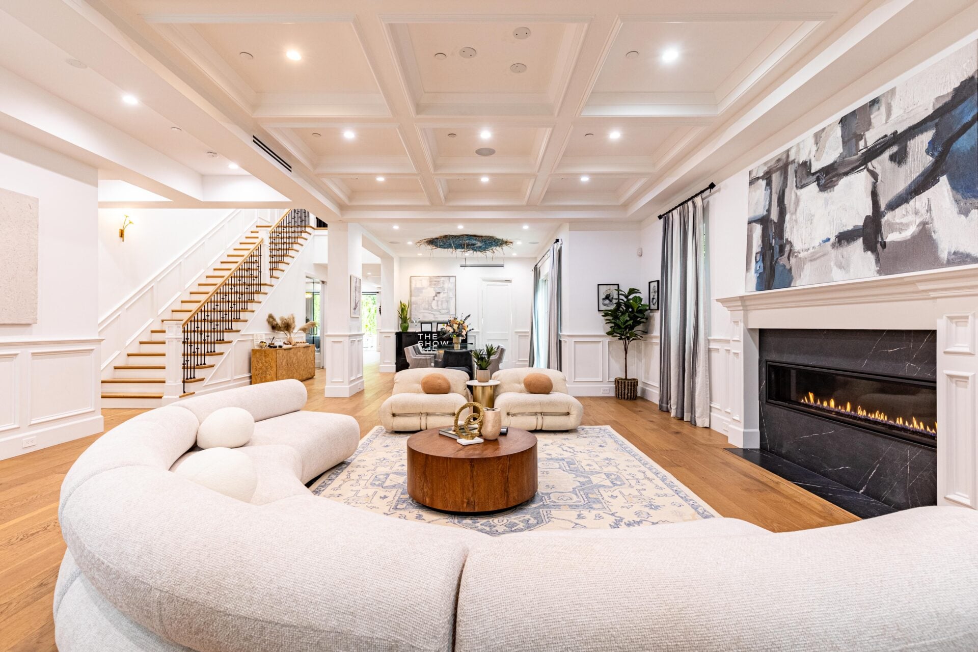 A coffered ceiling adds structure overhead, while white wall paneling wraps the lower half of the room.