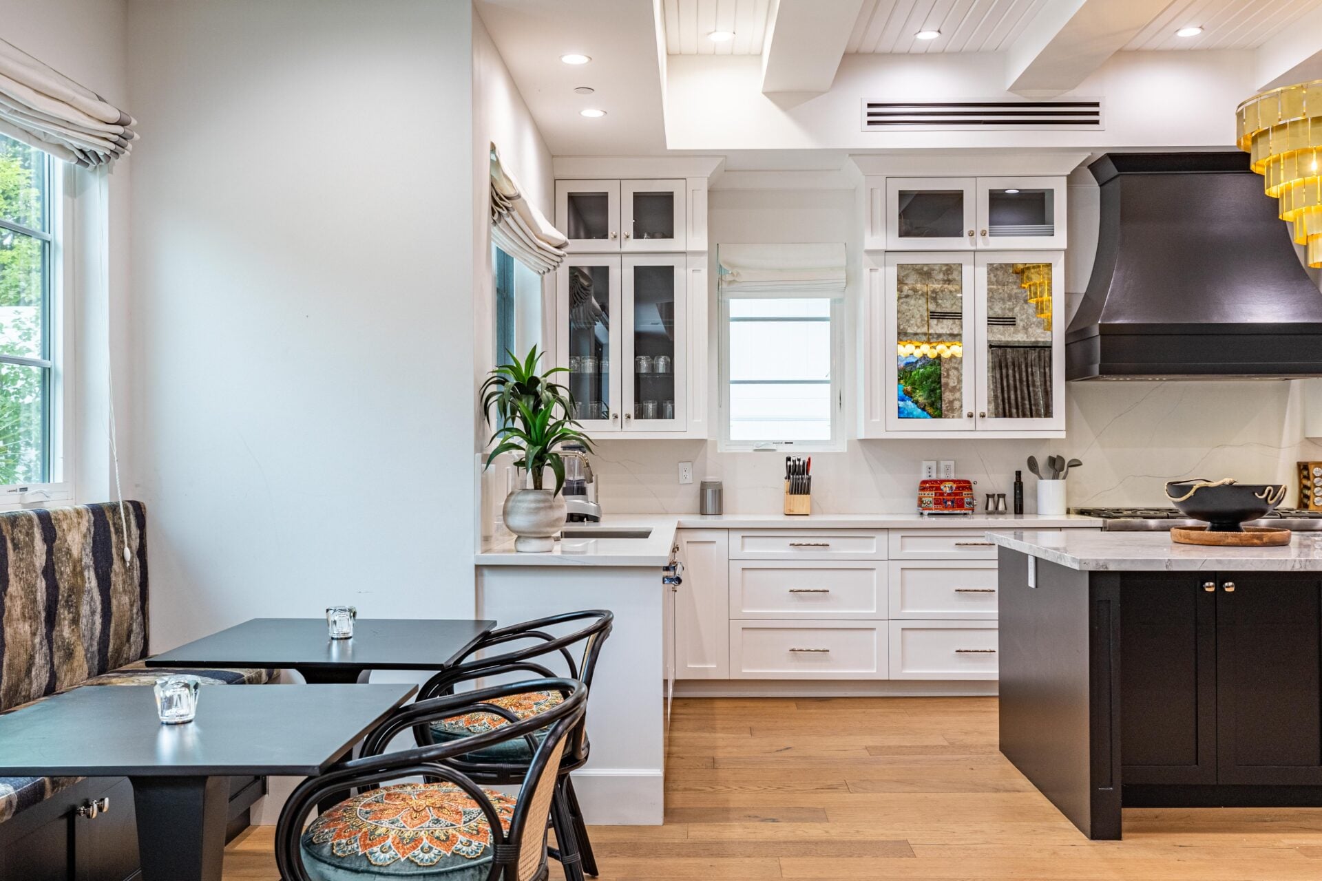 Just off the kitchen, a compact breakfast nook is tucked against the windows overlooking the backyard. 