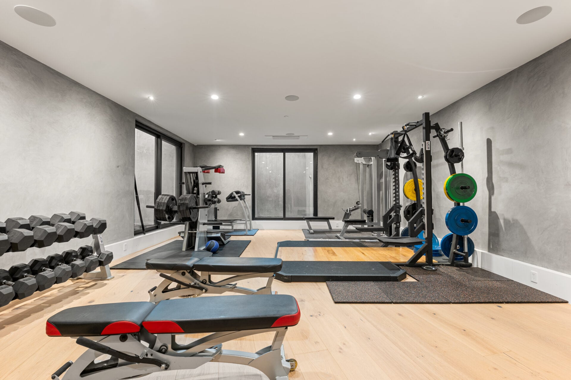A private training area, with weights and strength equipment spread across the room. 