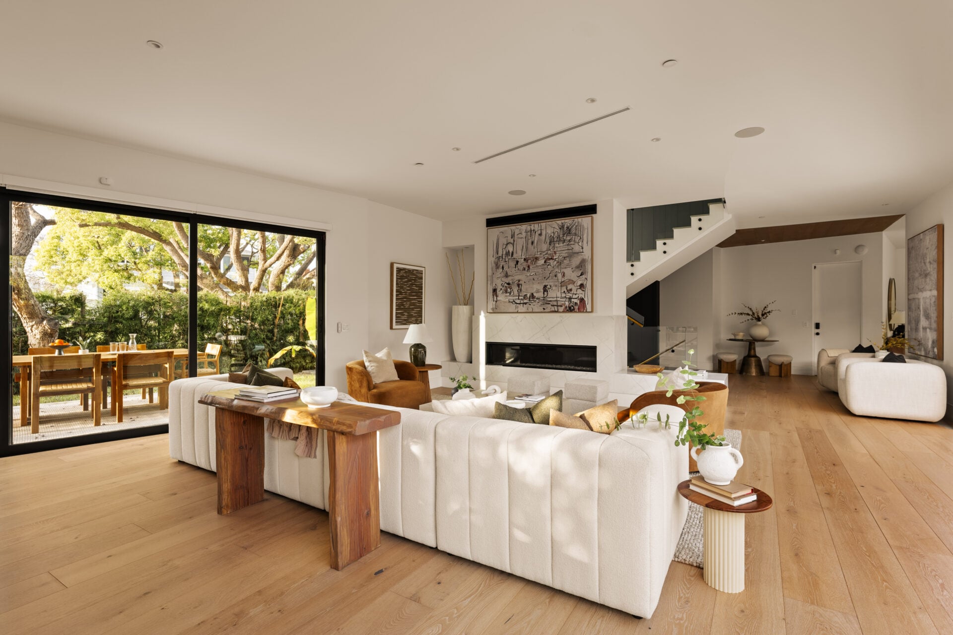 Beyond the entry, the home opens into a great room with a gas fireplace set into a marble wall. 
