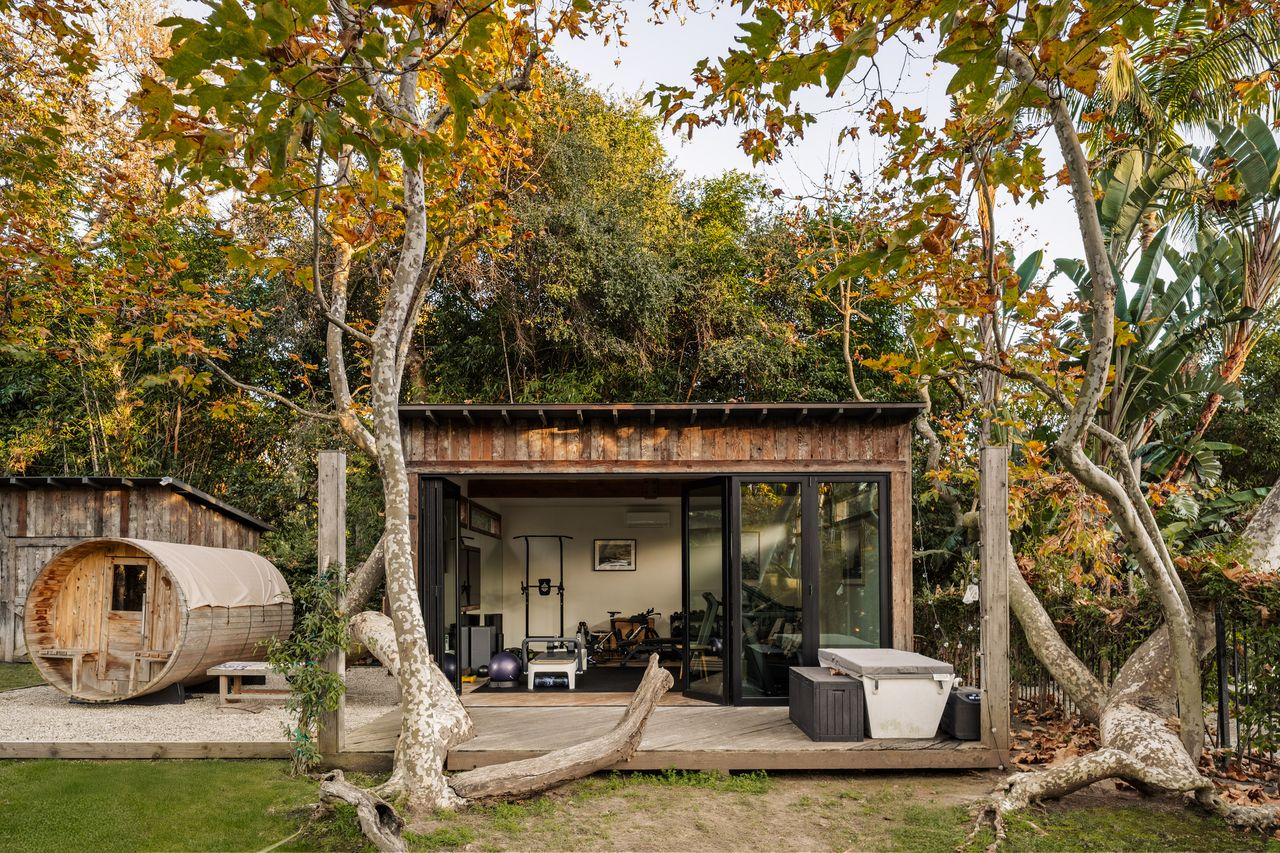 Sitting on a deck right outside the gym is a wellness area with a barrel-style sauna, cold plunge, and hot tub.
