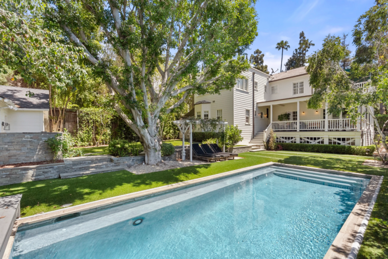 A long rectangular pool set into the lower level of the yard.