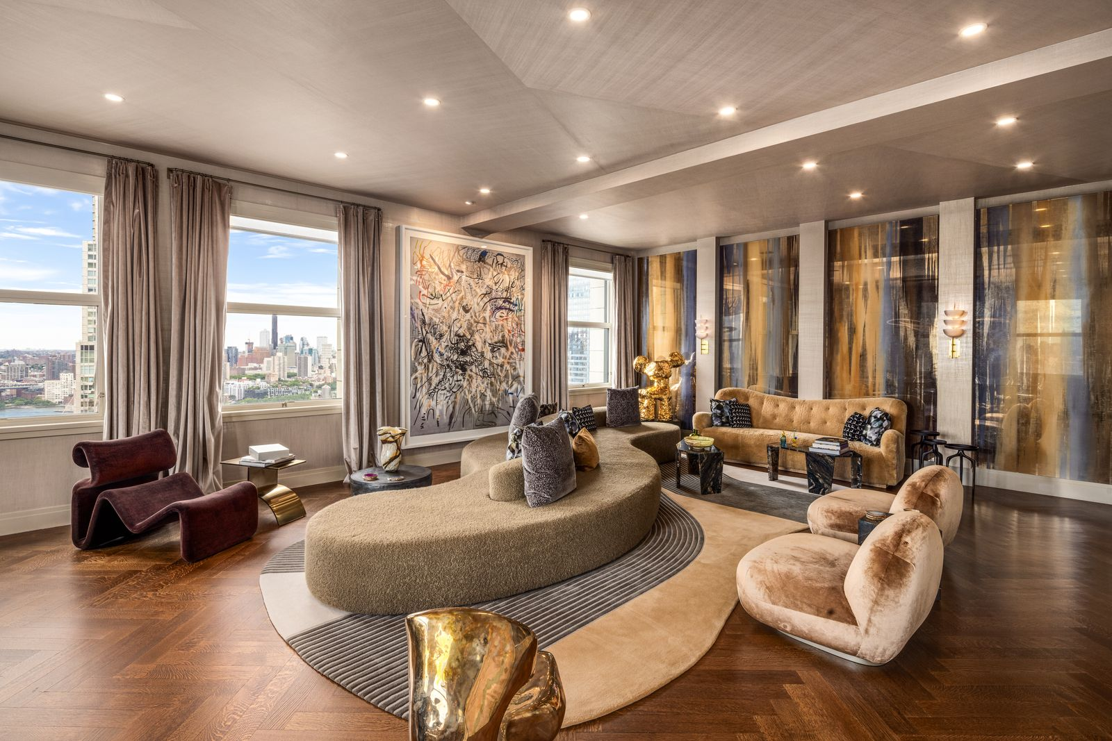 Within the living area, a sofa curves between a mix of chairs and side tables.