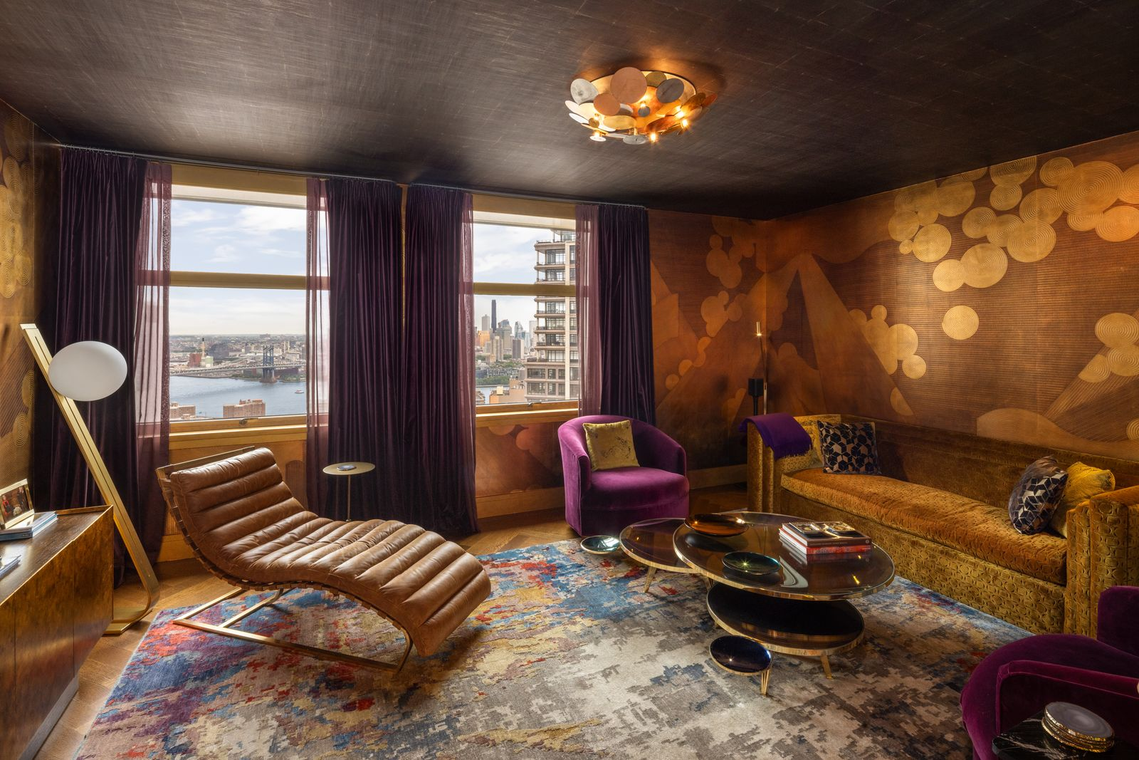 A media room, with custom de Gournay wallpaper in a layered gold and brown abstract pattern.