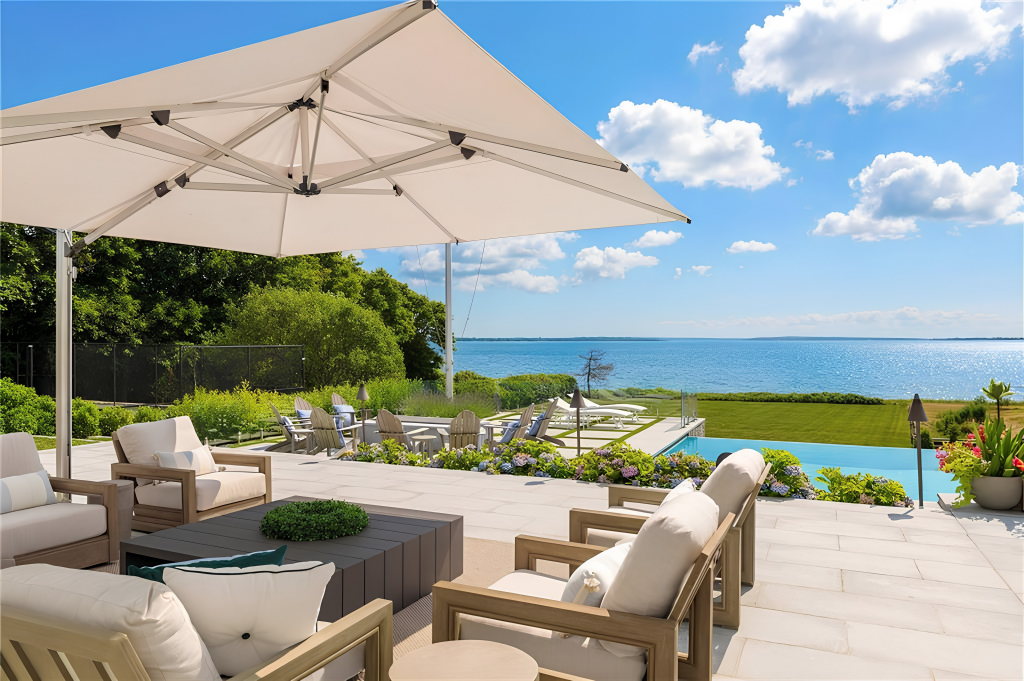 The terrace continues into the open air where additional seating and dining areas sit directly against the view.