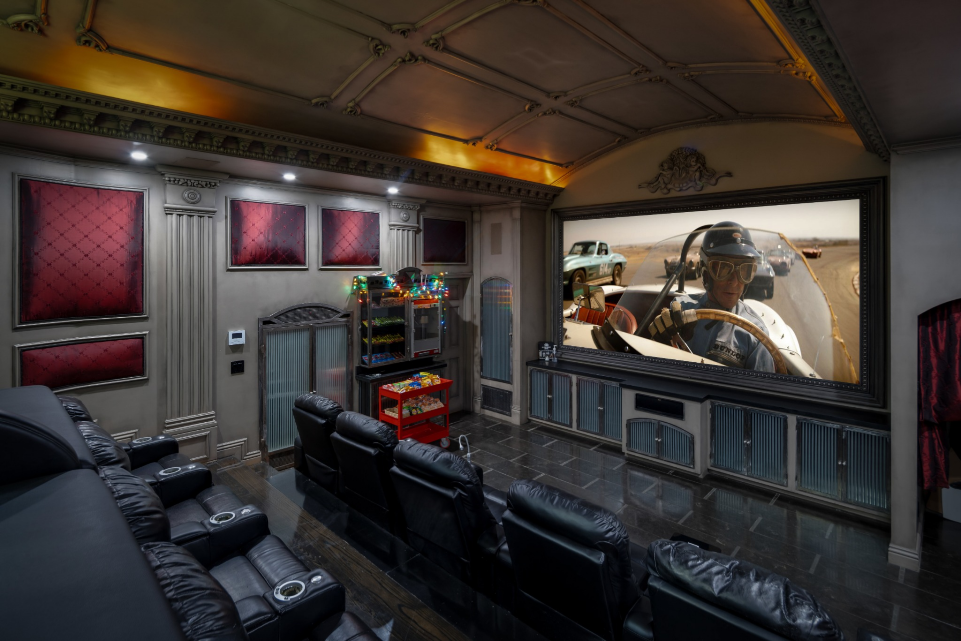 The theater has 15 reclining leather seats arranged across multiple levels in front of a large projection screen.