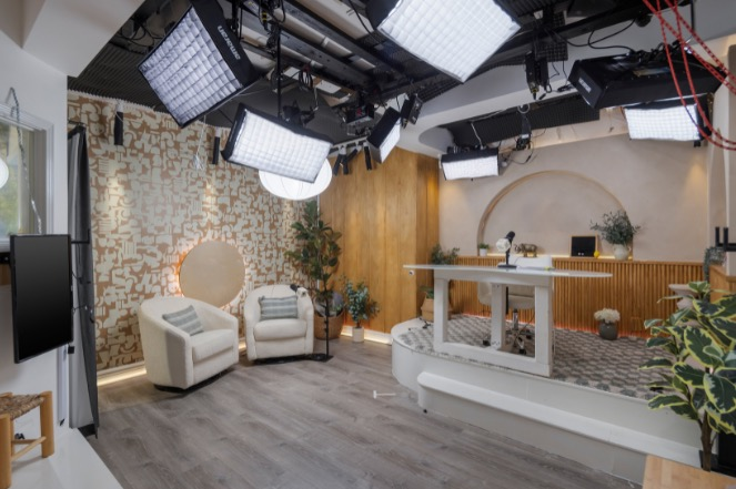 Podcast studio with overhead studio lighting.
