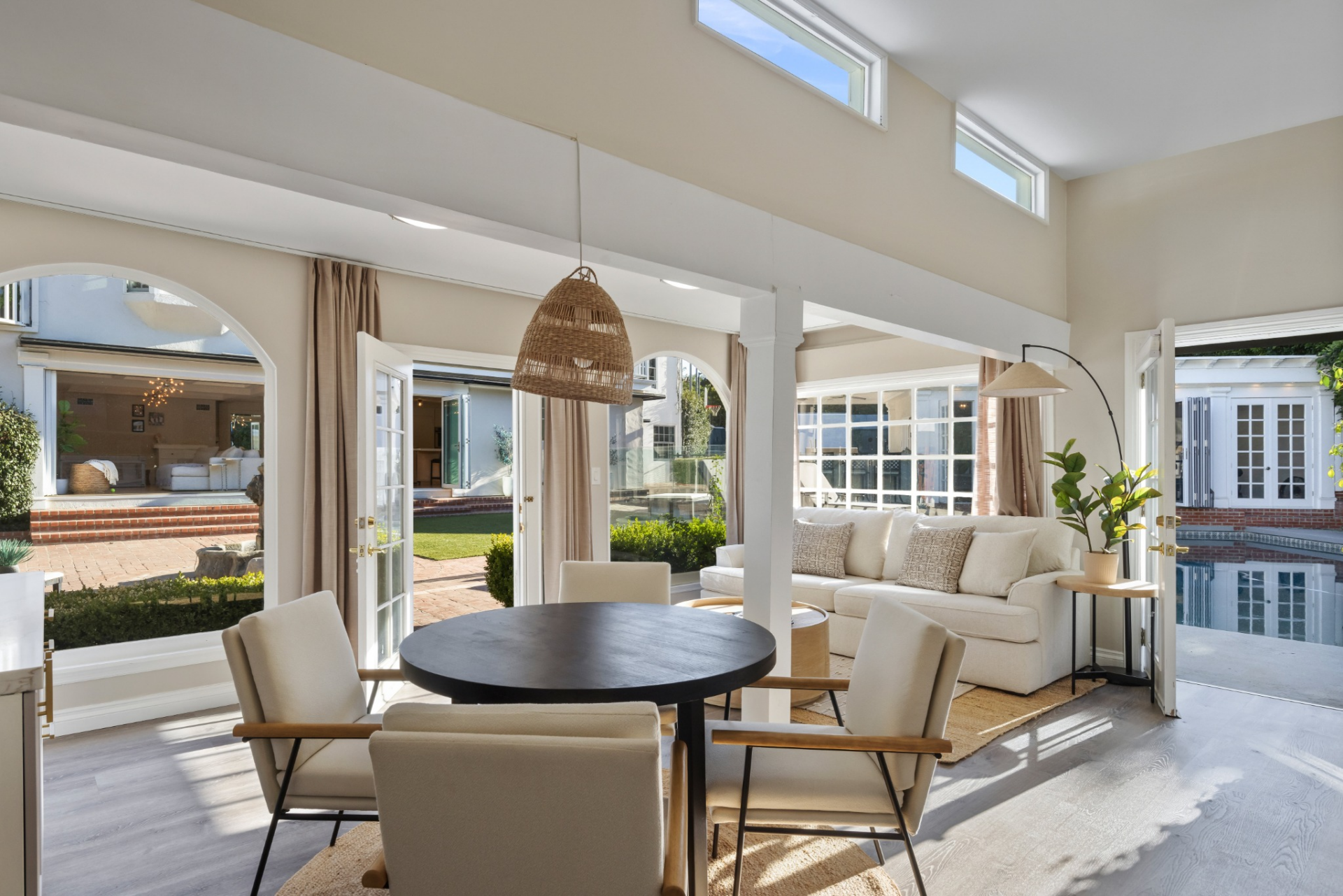 Detatched guest house with an open living area that combines a round dining table with a sitting space.