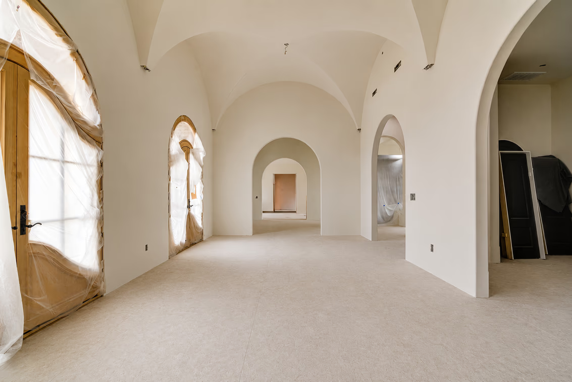 In the first space, the ceiling rises into a series of barrel-like curves, with repeated arches creating symmetry across the hall.