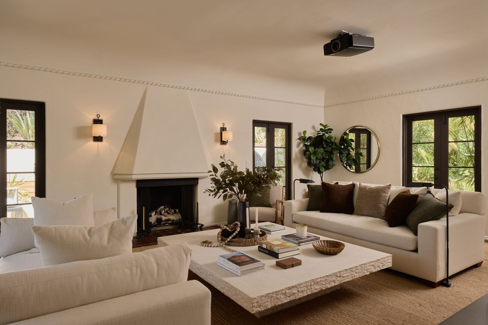 The main living room opens around two sofas and several chairs grouped around an oversized square coffee table. 
