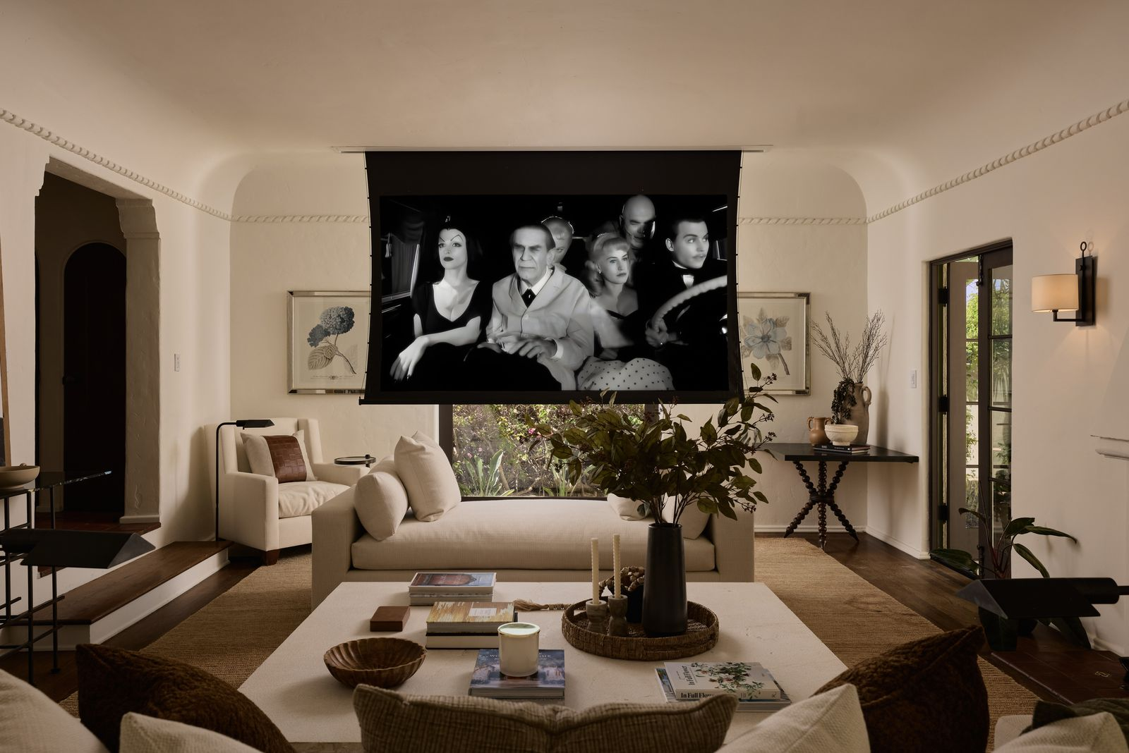 While the room may look more formal, a hidden projection screen actually sits in front of the picture window.