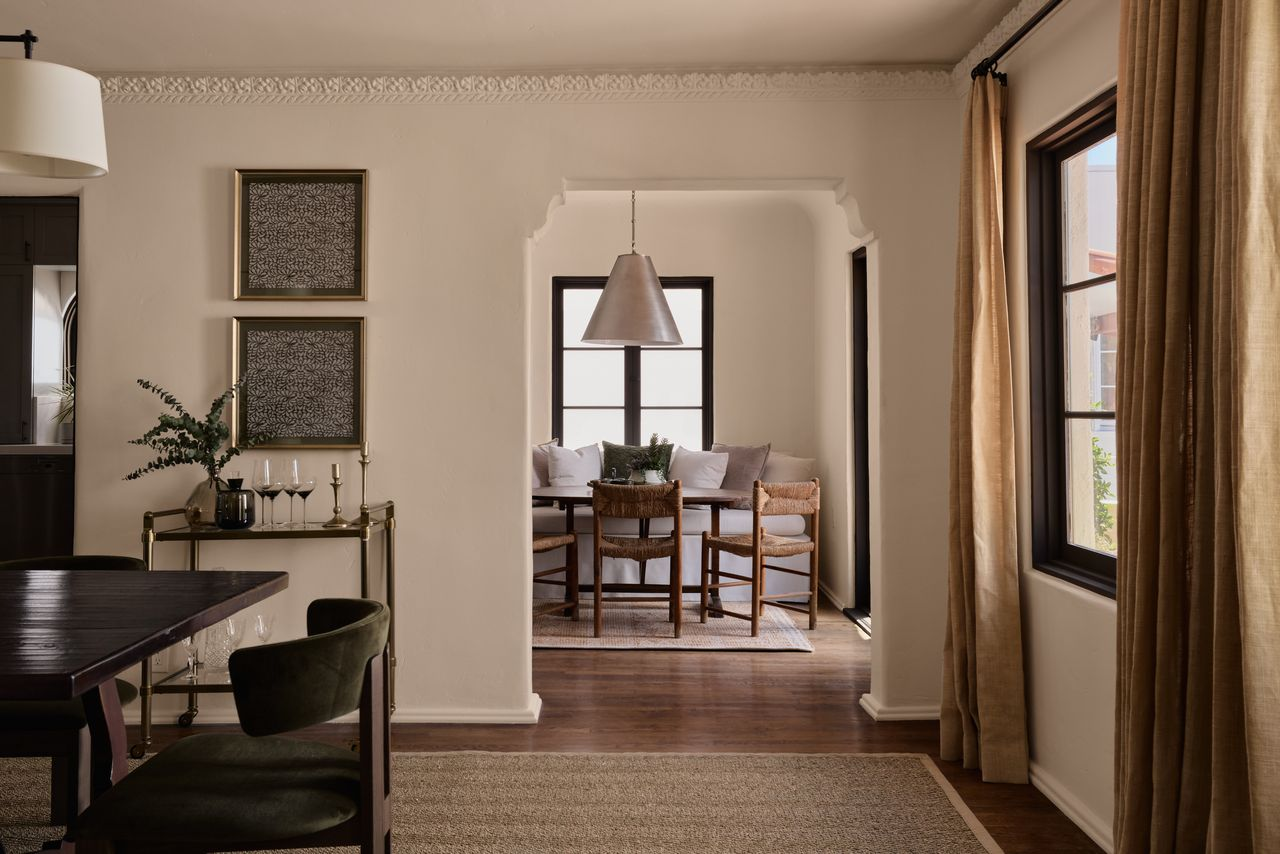 Through an open archway, a smaller breakfast nook is tucked into a corner of the house beside the kitchen. 