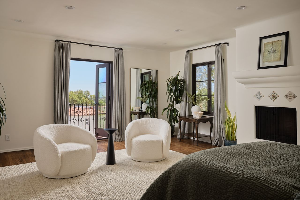 A pair of rounded lounge chairs which sit in front of the suite's private balcony.