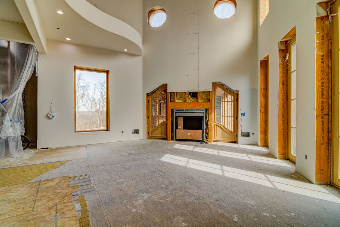A family room, with its double-height proportions and built-in media wall.