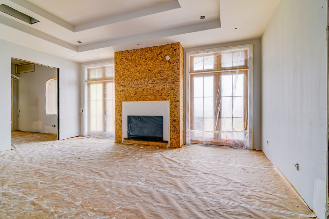Another nearby living space features a fireplace centered between two tall sets of windows. 