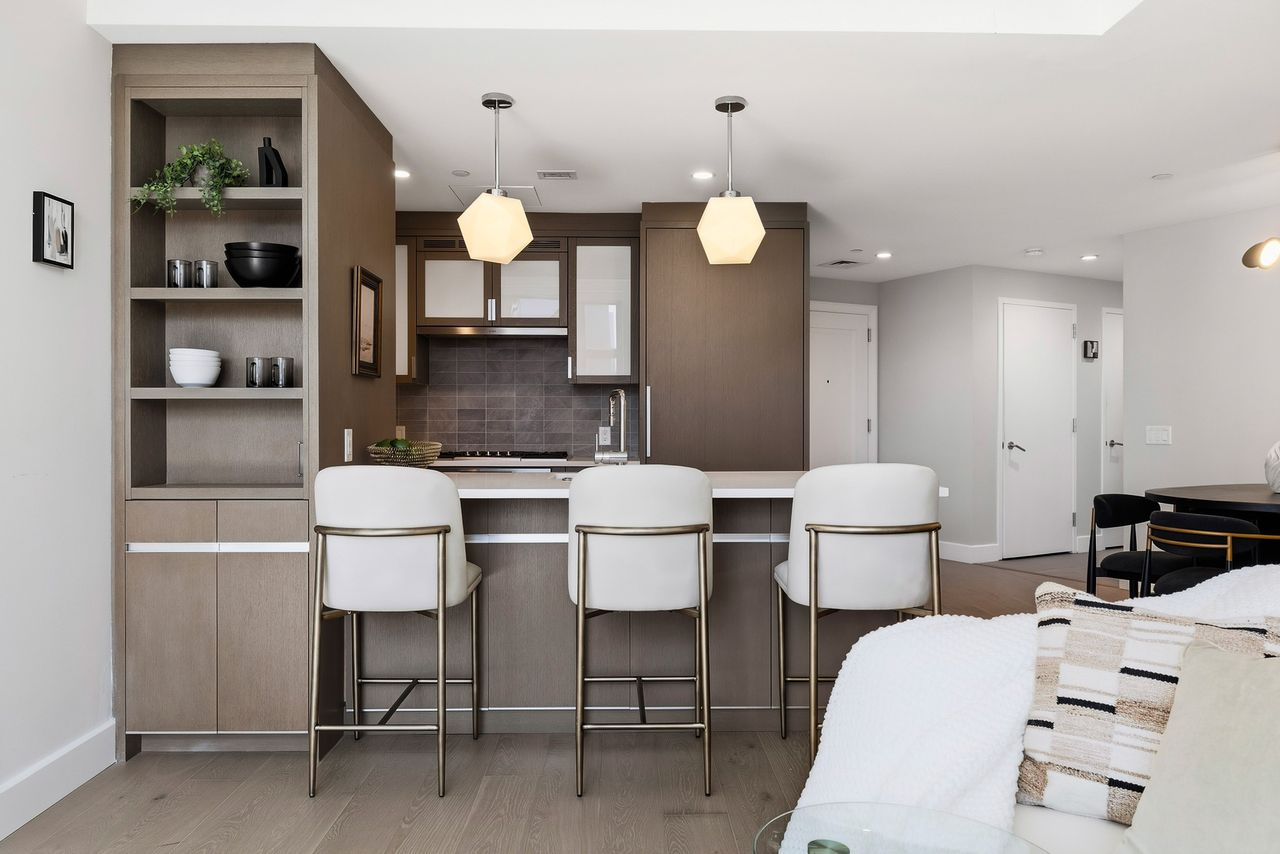 The kitchen stays open to the main room, with an island and breakfast bar creating a slight separation between the two spaces. 