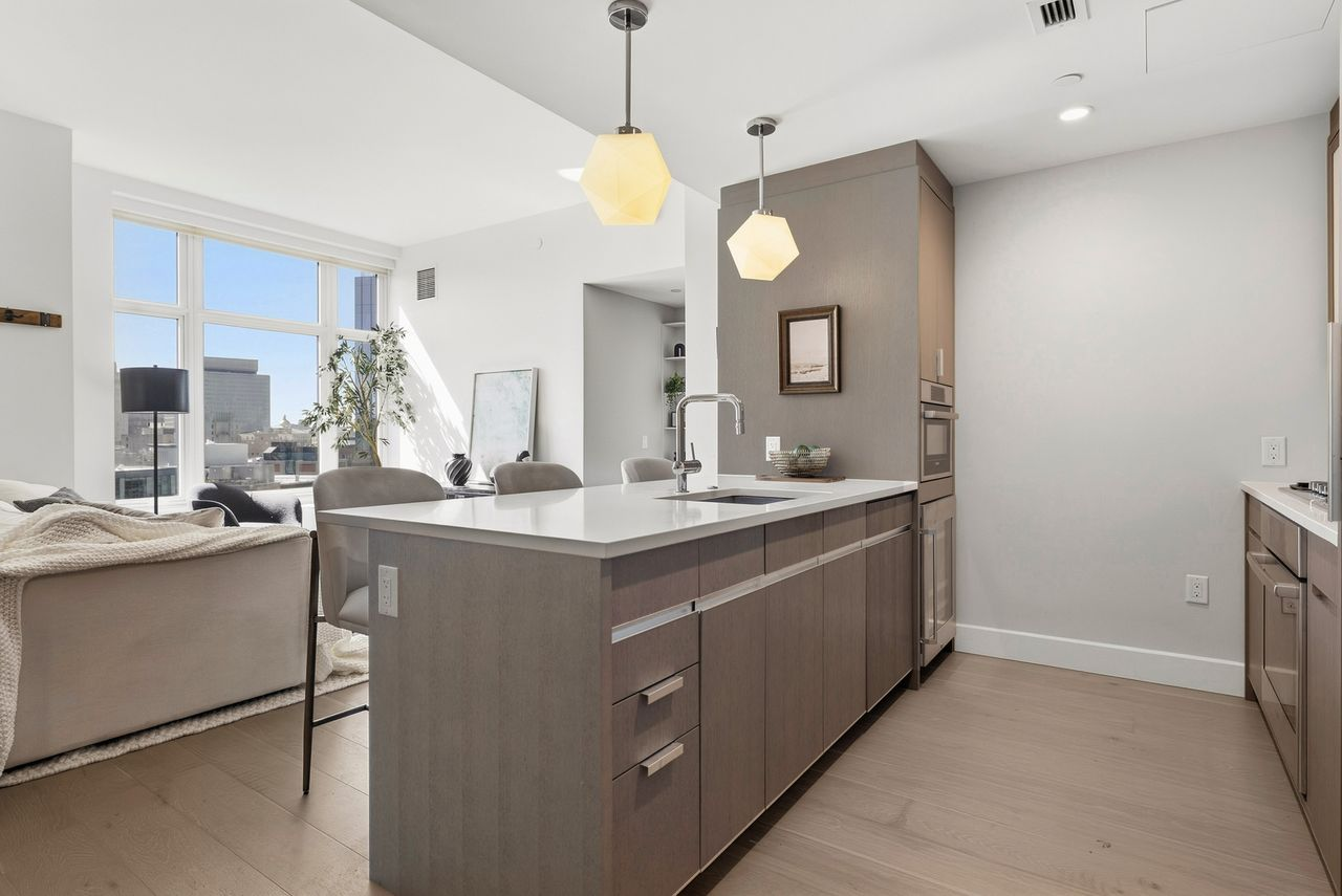 Custom cabinetry conceals integrated Bosch and Gaggenau appliances in the kitchen.