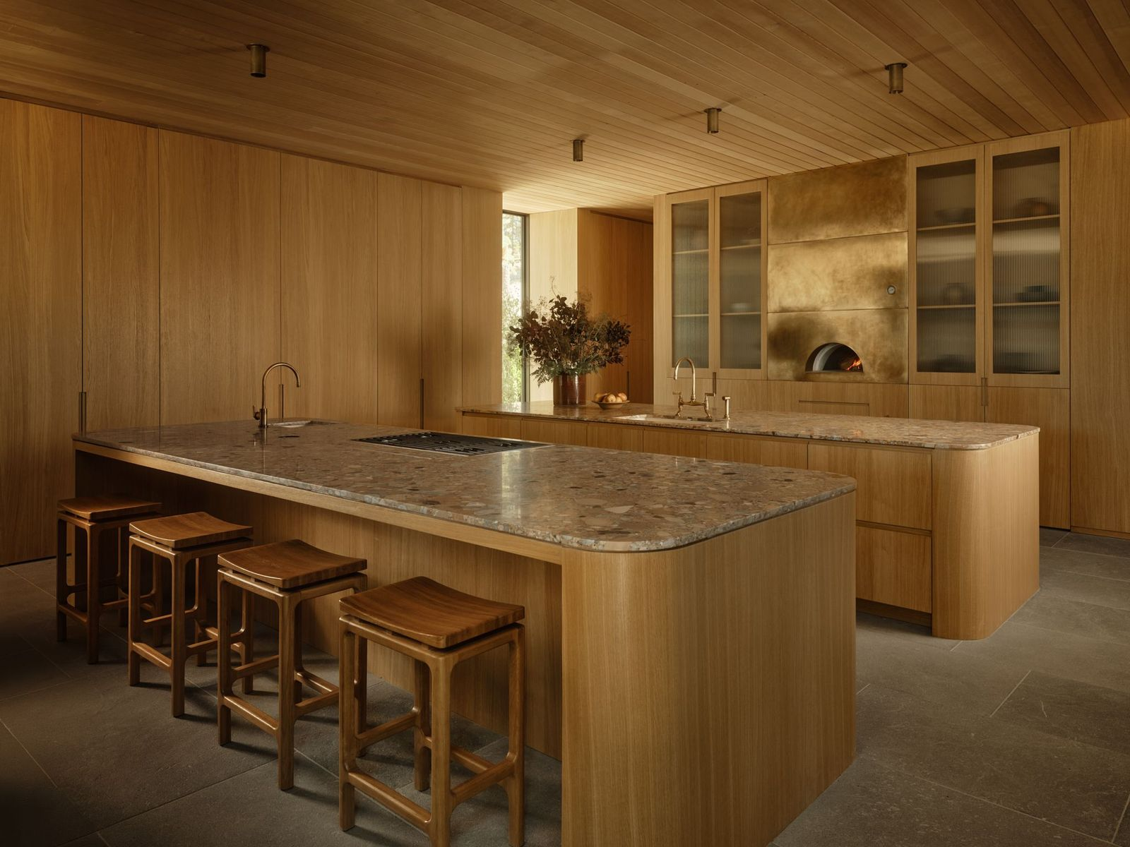 The chef’s kitchen features two large islands topped in Ceppo Rosa stone. 