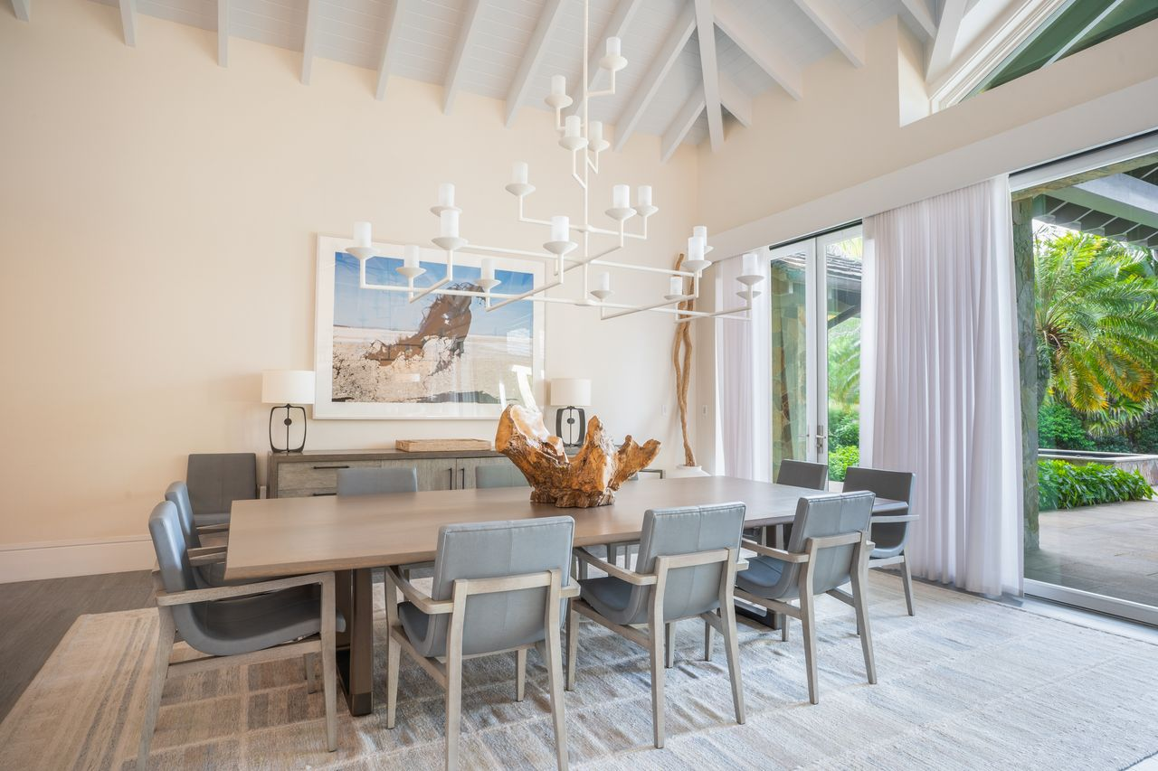 The dining area is centered on a long rectangular table with seating for ten. 
