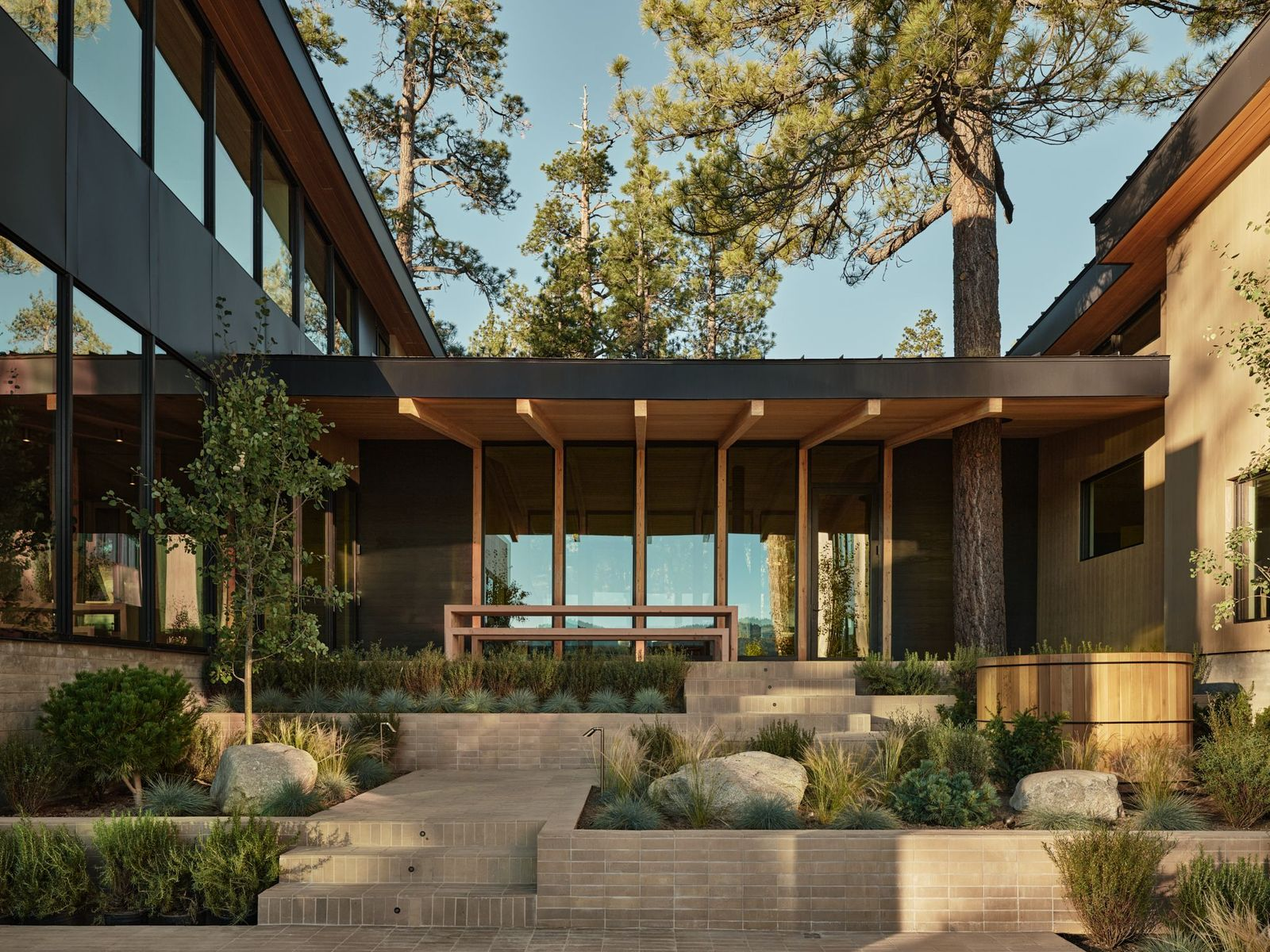 The main living areas open directly into the central courtyard, beginning at the upper level with a covered dining pavilion set beneath the roofline. 
