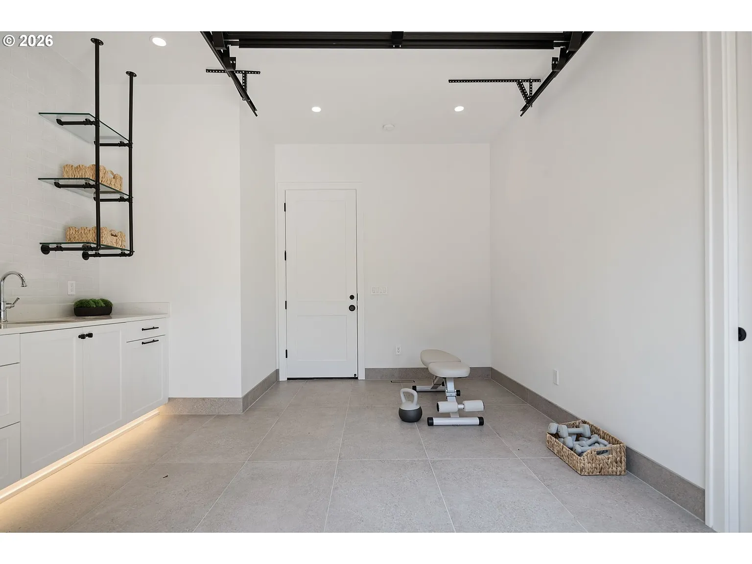 A compact workout space, but the open floor area leaves plenty of room for the next owner to rework it around entertaining instead.