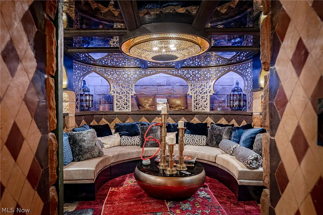 A hookah lounge where a built-in banquette curves around a round central table.
