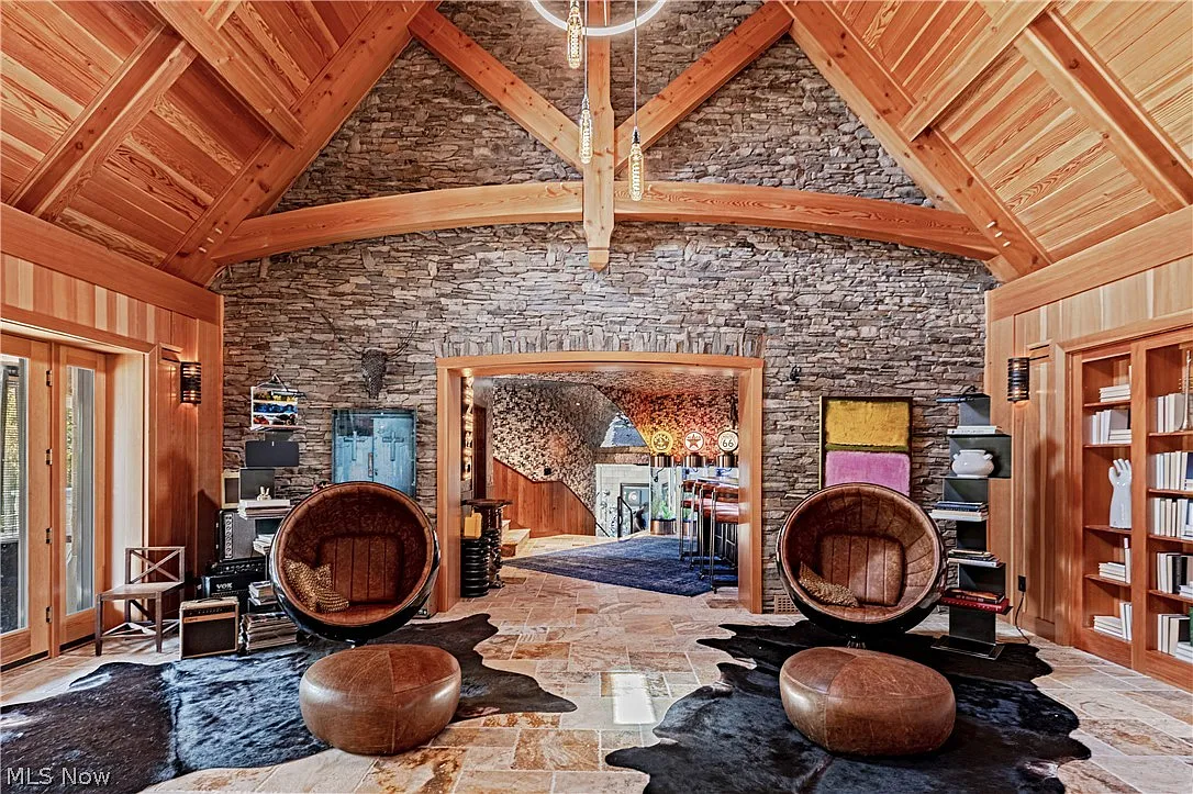 Connected directly to the cocktail lounge, the next space opens into a much larger gathering room beneath a vaulted timber ceiling.
