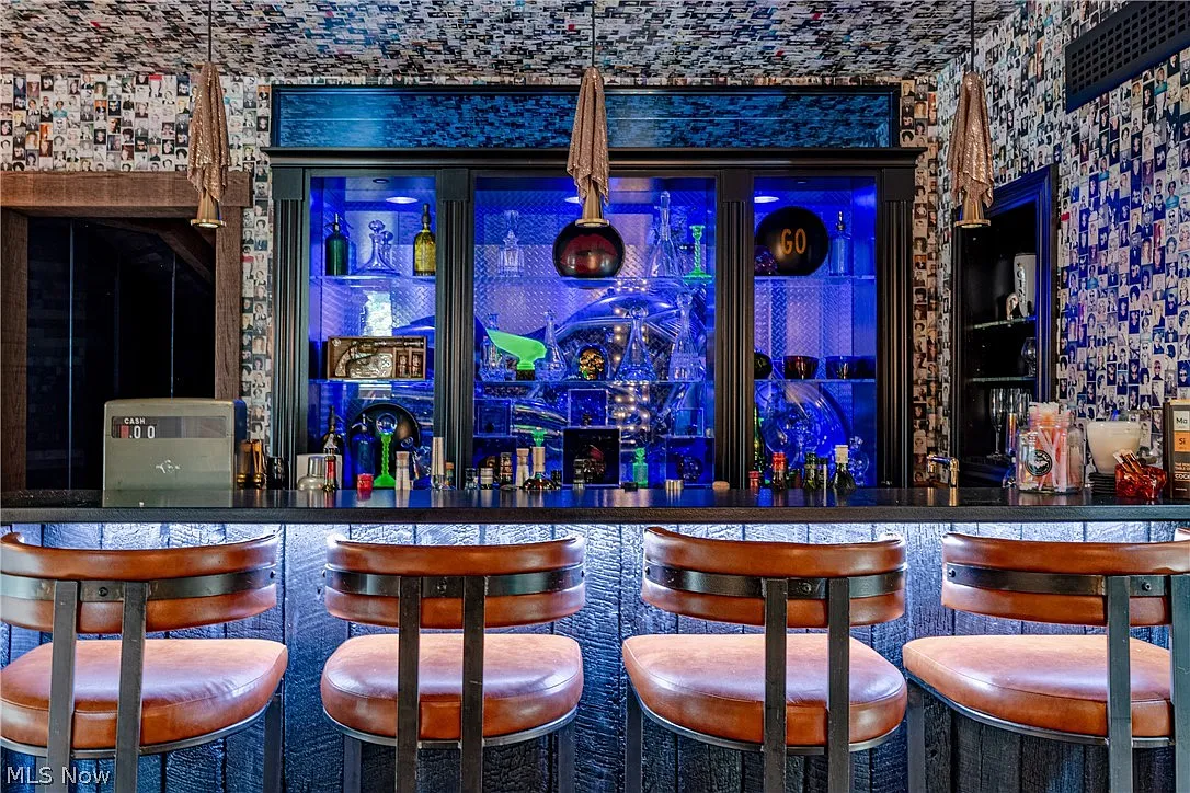 Harley-Davidson motorcycle displayed behind the bar's glass cabinetry as part of the backdrop, turning it into a focal point rather than simply another collectible.