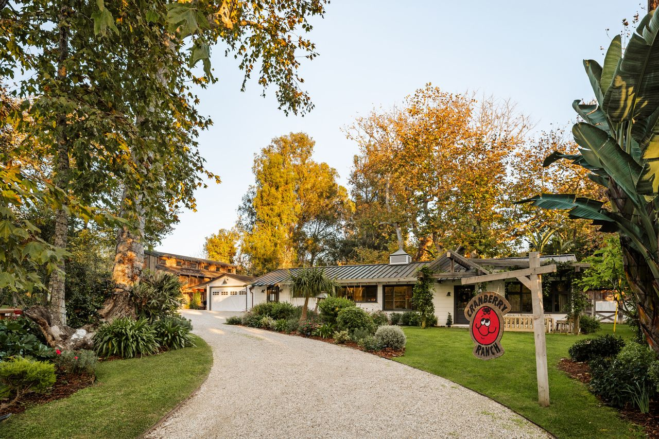 As the drive reaches the residence, a “Cranberry Ranch” sign welcomes you in before it curves toward the side of the home where the garages are.
