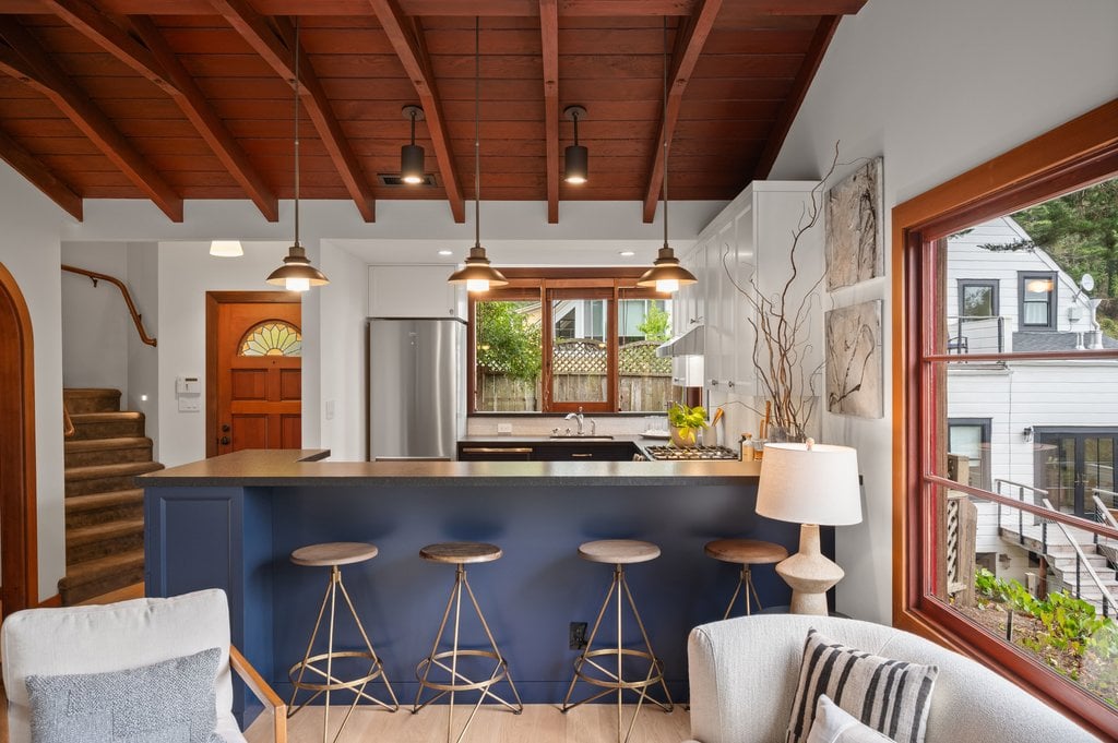 Kitchen with stainless-steel appliances to pair with the white upper cabinetry and darker lower cabinets.