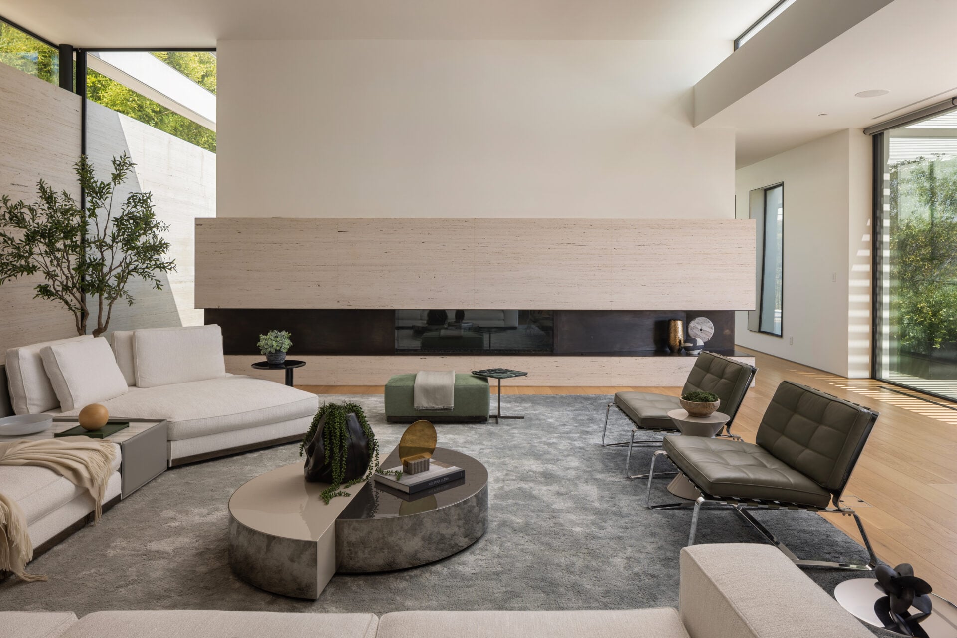Just past the entry, the formal living room is placed alongside the main hallway with a horizontal stone fireplace.