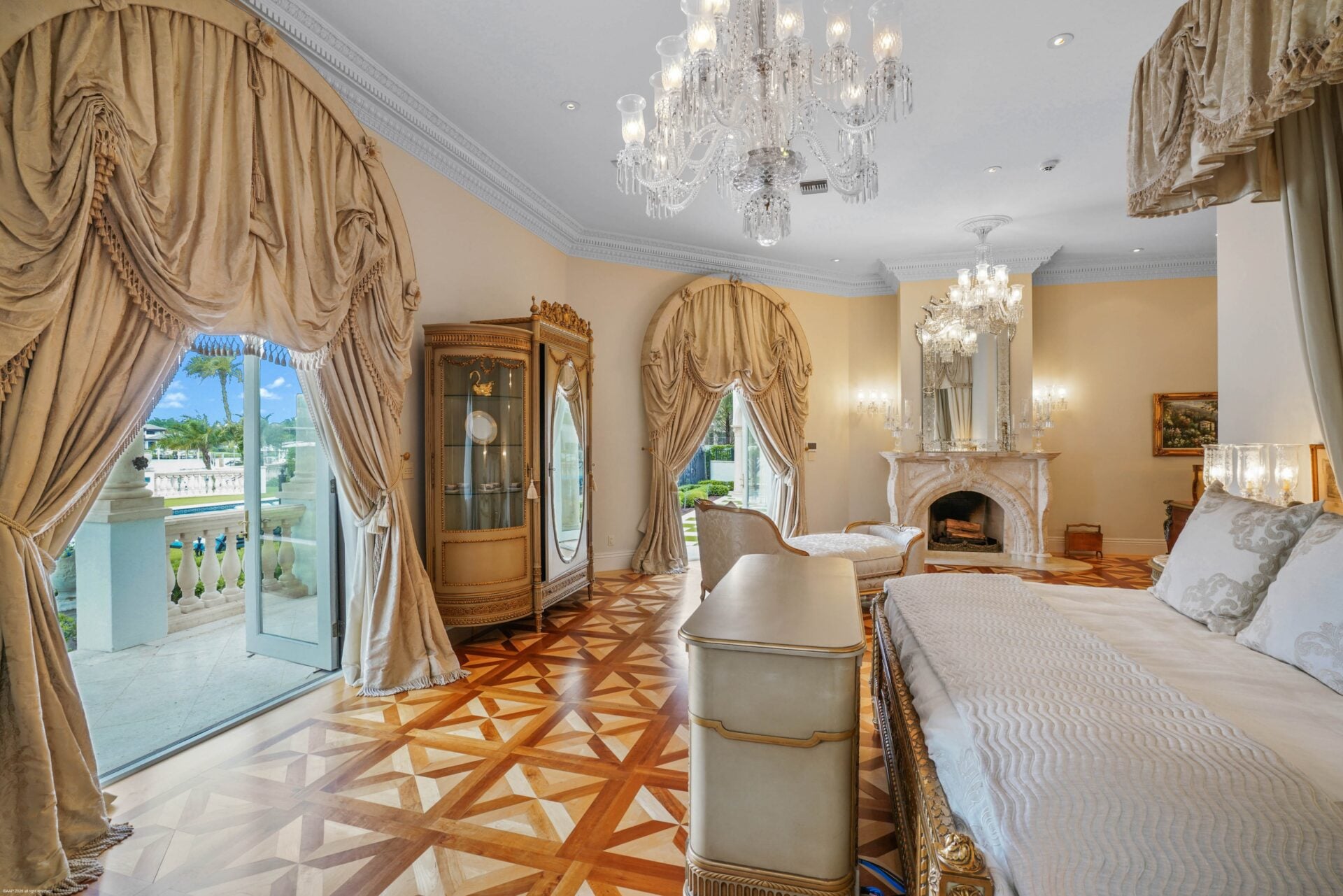 The bed sits farther into the room facing a set of glass doors that open directly to the outdoors.