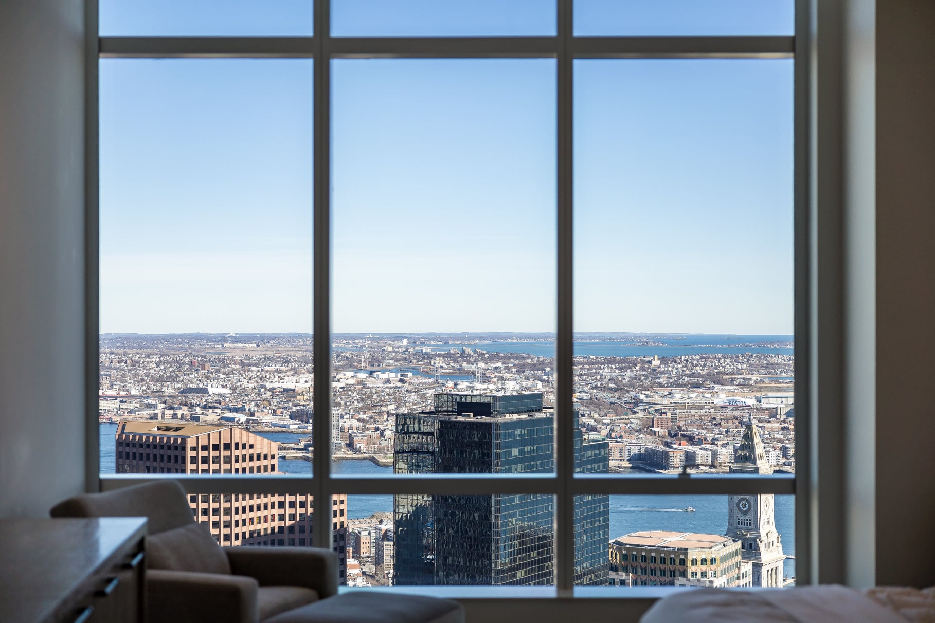 Views of Boston through a full wall glass window.
