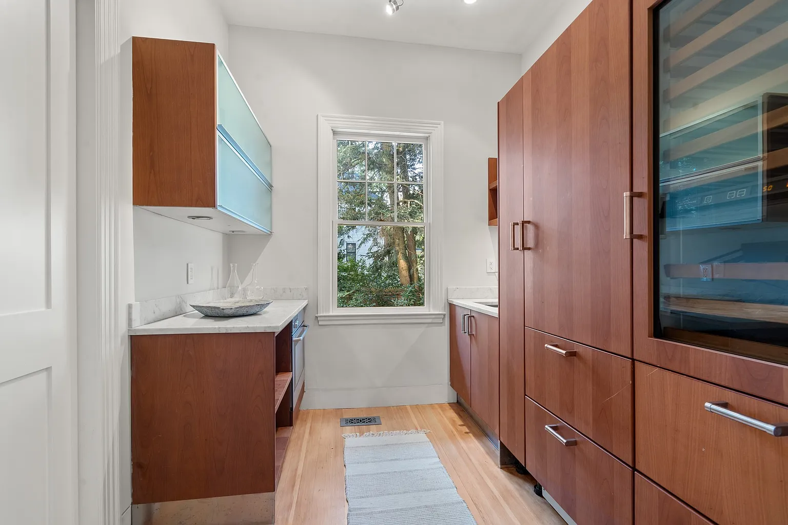 A secondary catering kitchen with additional prep space, storage, and built-in wine refrigeration.