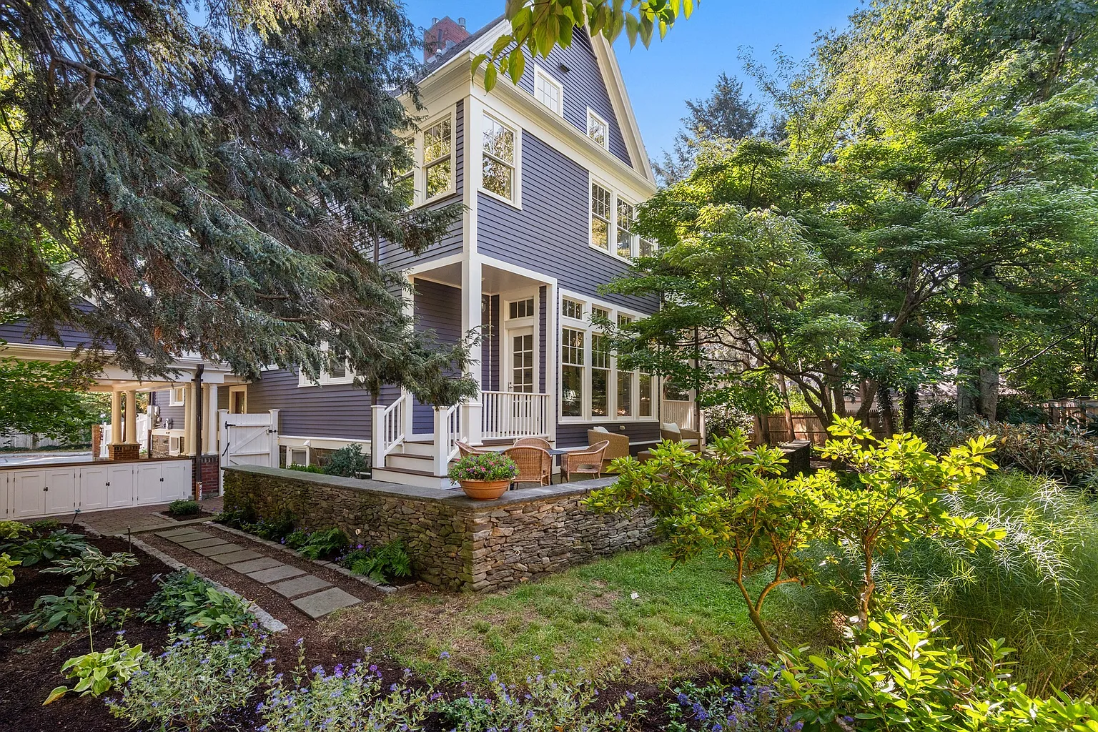 The terrace creates several places for outdoor dining and lounging before steps and pathways lead down into the more densely planted portions of the yard.