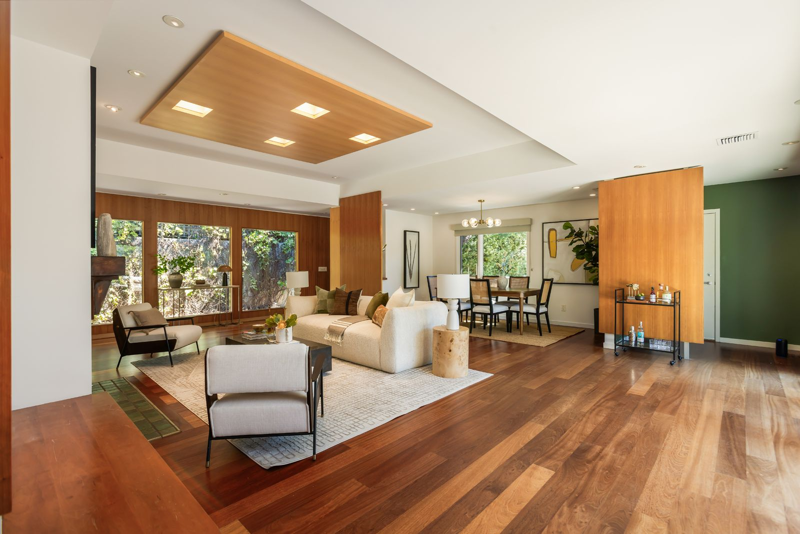 Hardwood floors and wood accents flow through an open living and formal dining area.