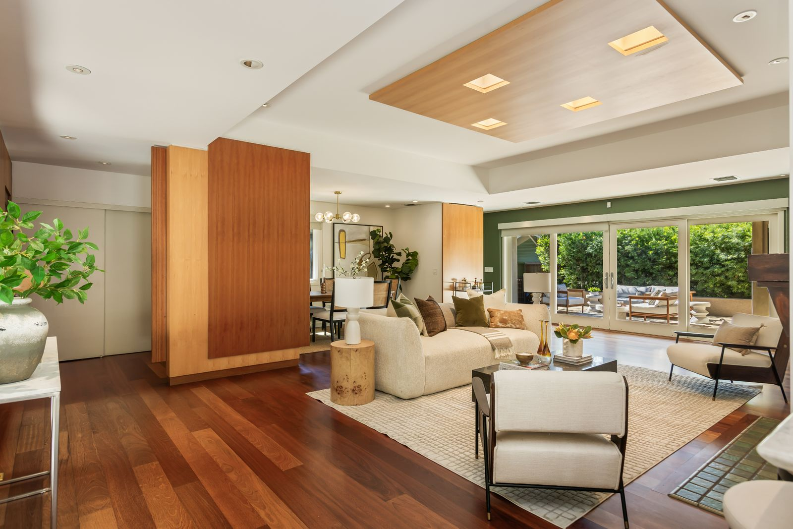 Along the outer walls, large windows and sliding glass doors keep the landscaped backyard in view, with the doors opening directly to the pool patio.