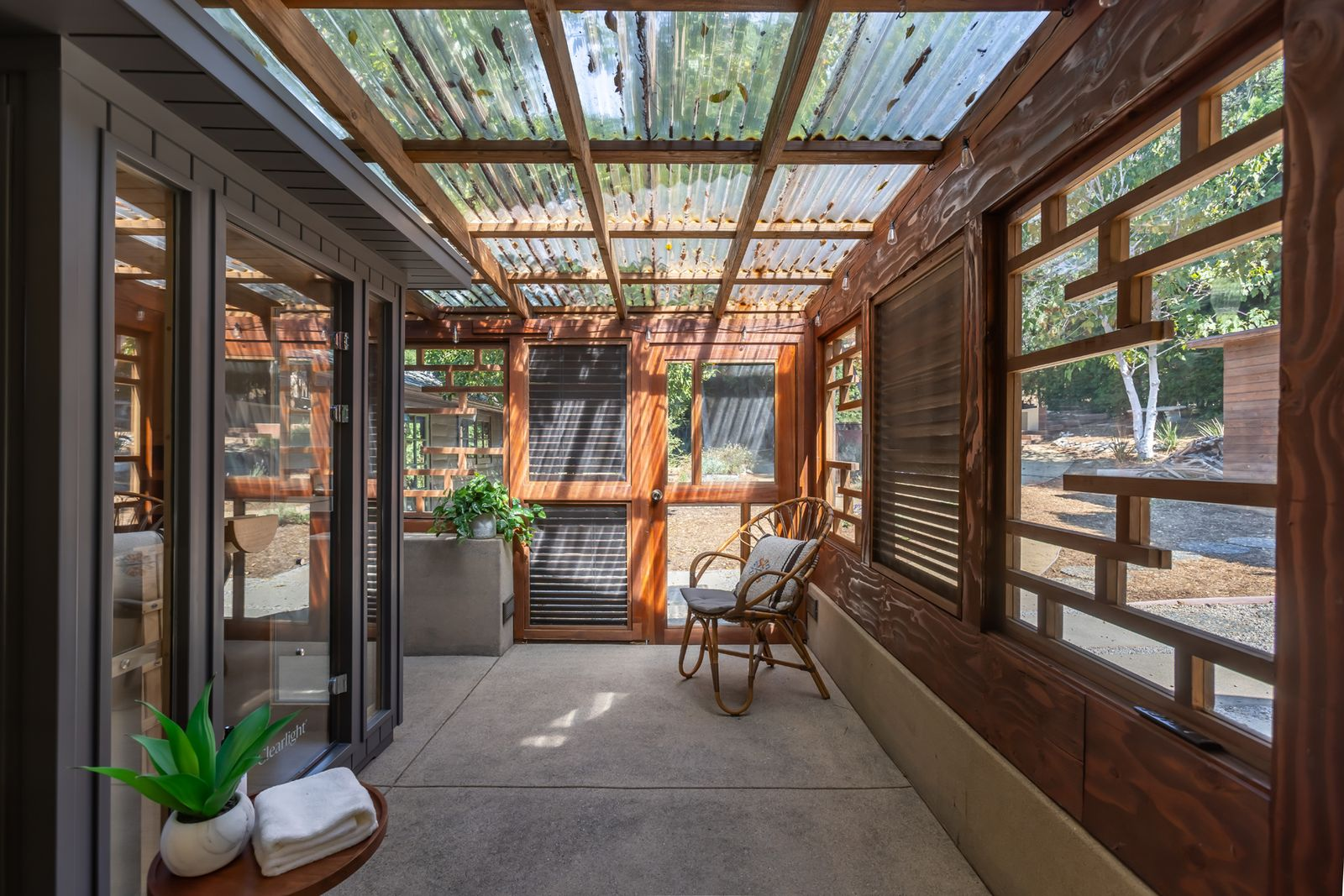 Wood-framed openings line the exterior walls, while a private sauna is placed in the center of the back wall.