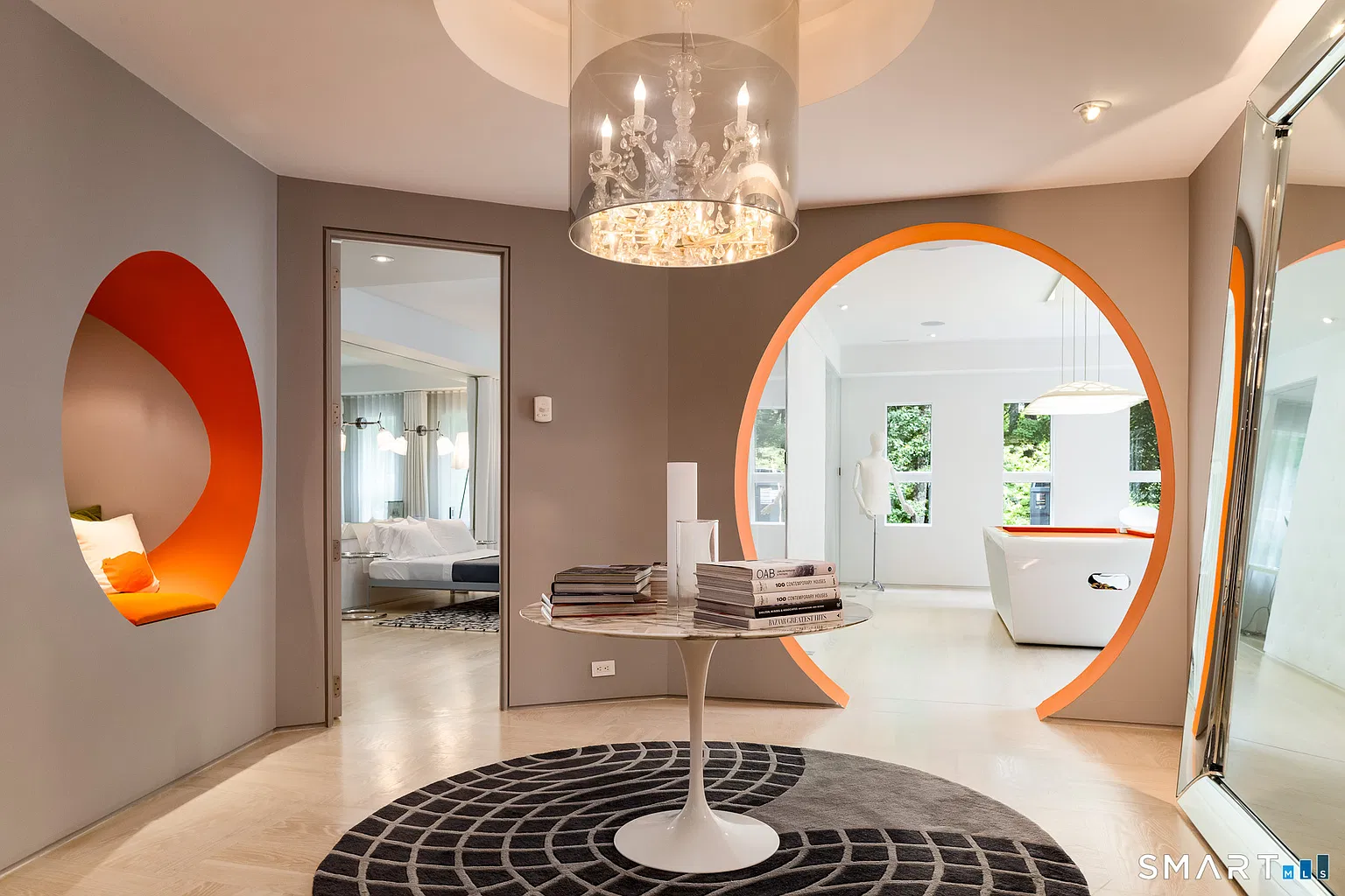 The entertainment area begins at a central hall where circular openings edged in orange connect the surrounding rooms.
