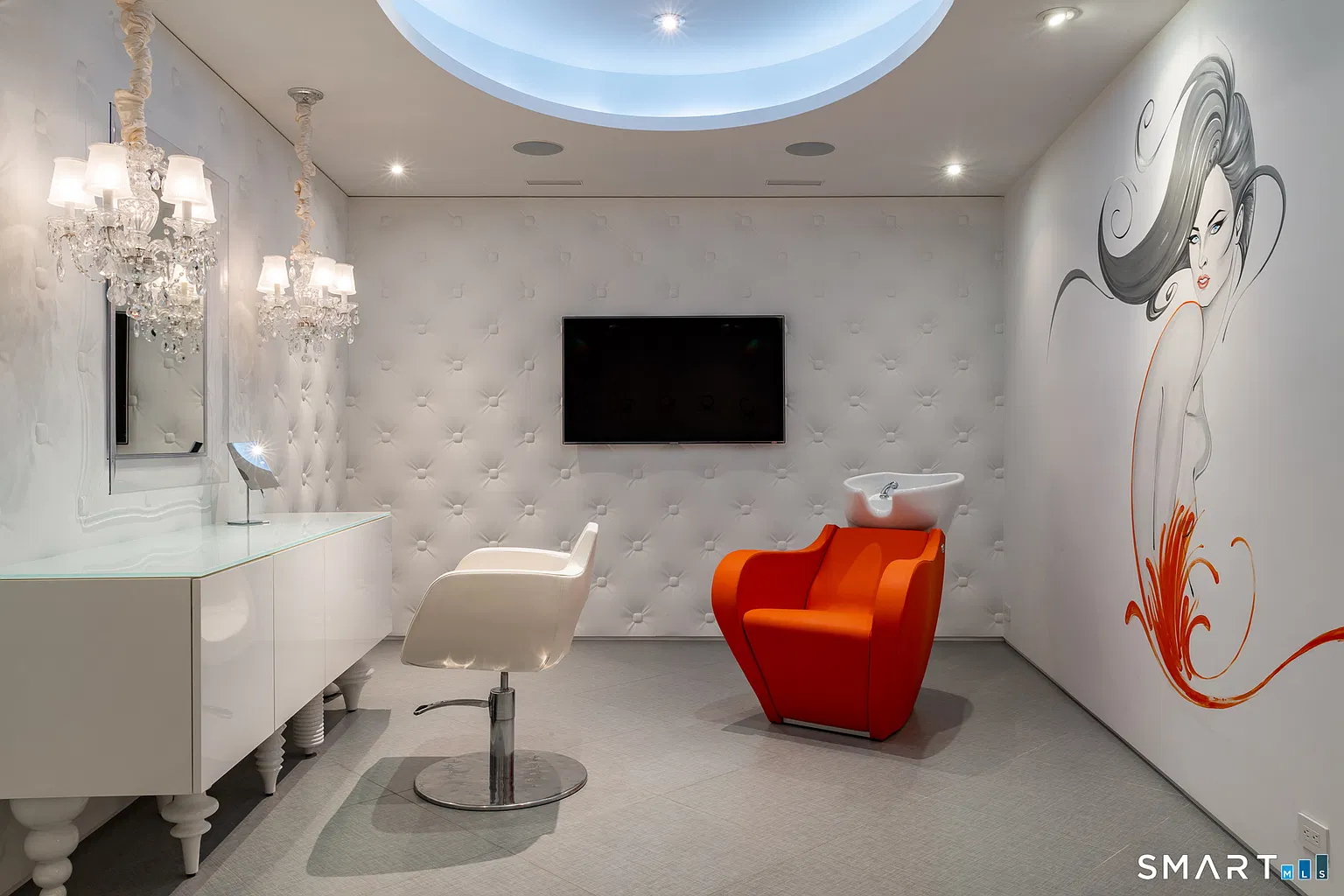 A private salon with a hair washing station, a hair cutting vanity, and a TV.