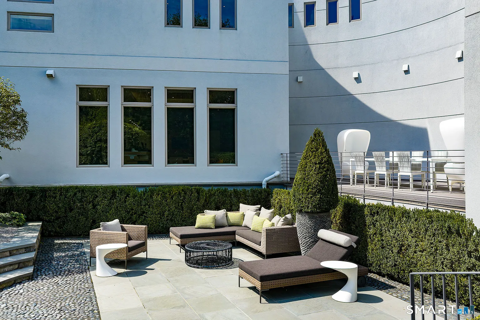 Directly outside the main house, stone terraces create separate areas for dining and relaxing while remaining closely connected to one another.