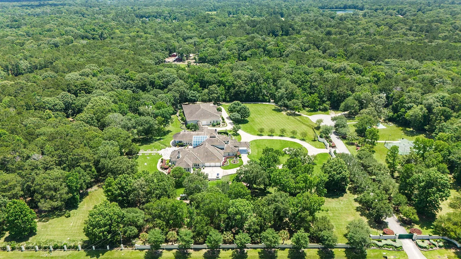 The property opens to the remaining 13.49 acres, which are spread out behind and to the sides of the center mansion.