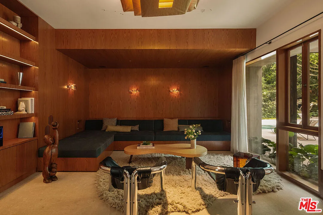 A built-in L-shaped couch surrounded by wood walls.