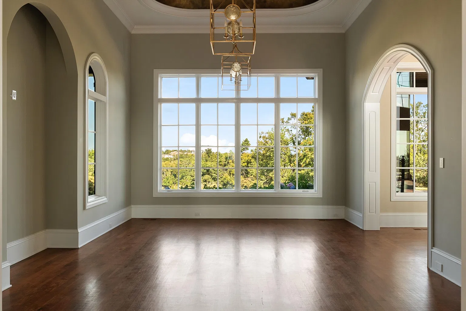 An arched opening off the great room leads into the formal dining room, which looks out to the front of the property.