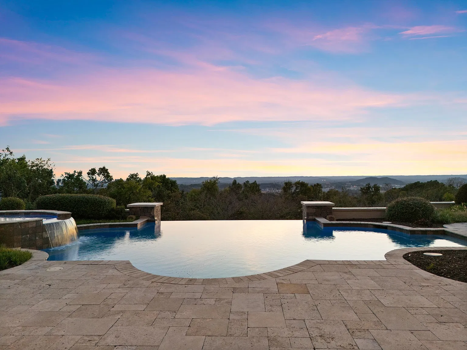 The water runs toward the edge of the property, opening the view across the rolling Tennessee hills.