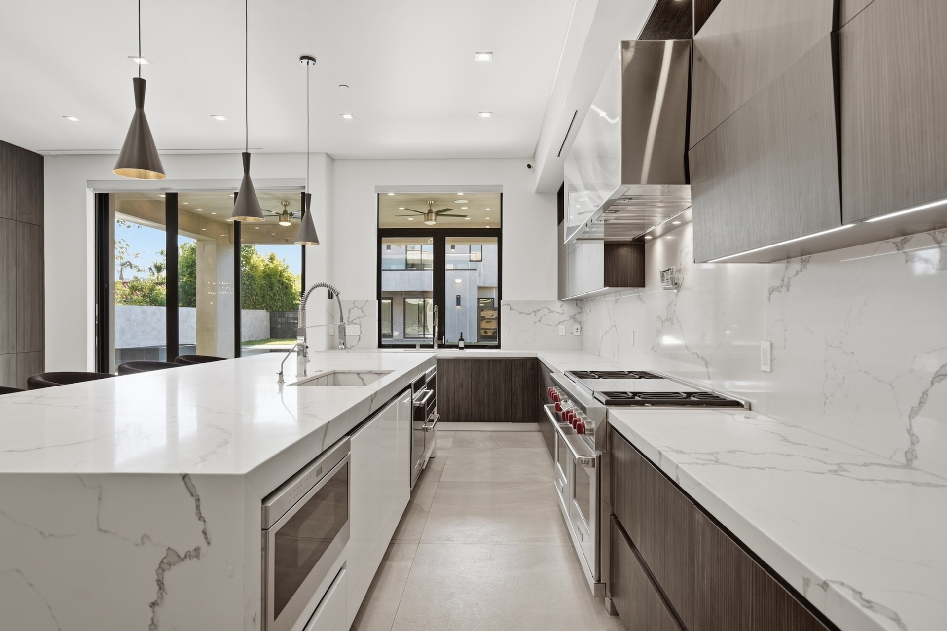 Dark custom cabinetry wraps the back wall around a professional-style range.