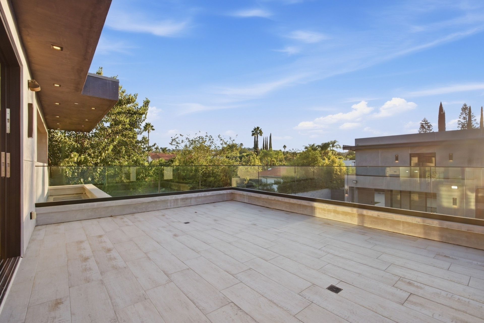 Large sliding glass doors open directly onto a private balcony overlooking the backyard.
