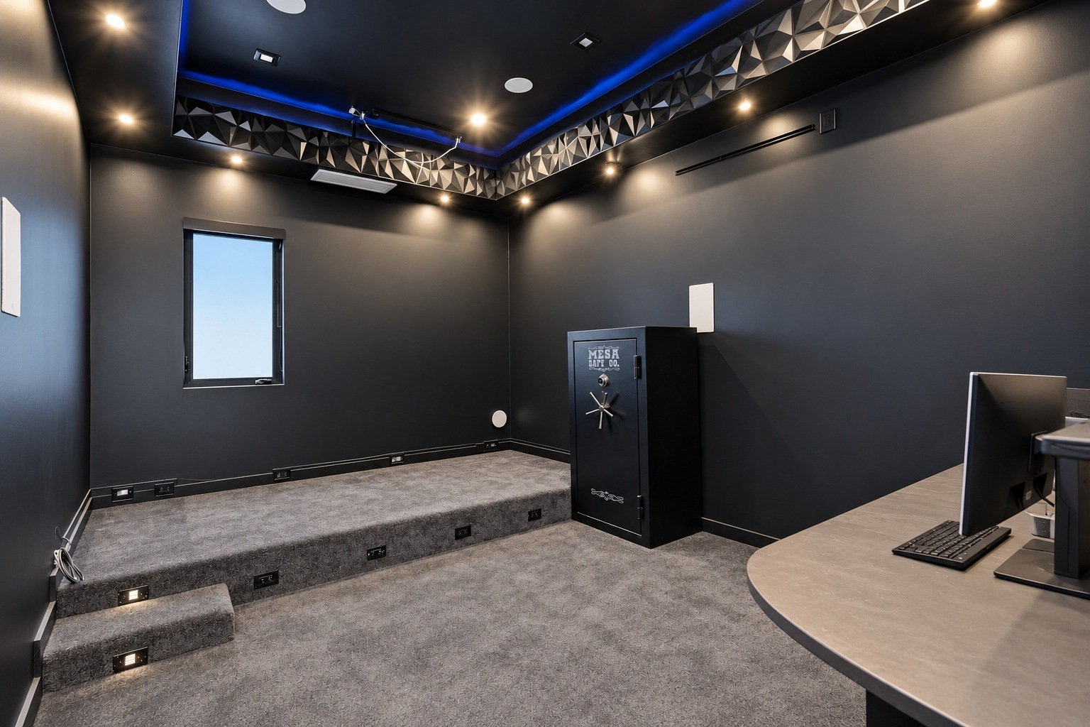 The home theater is tucked into a dark, enclosed room designed around a tiered viewing platform.
