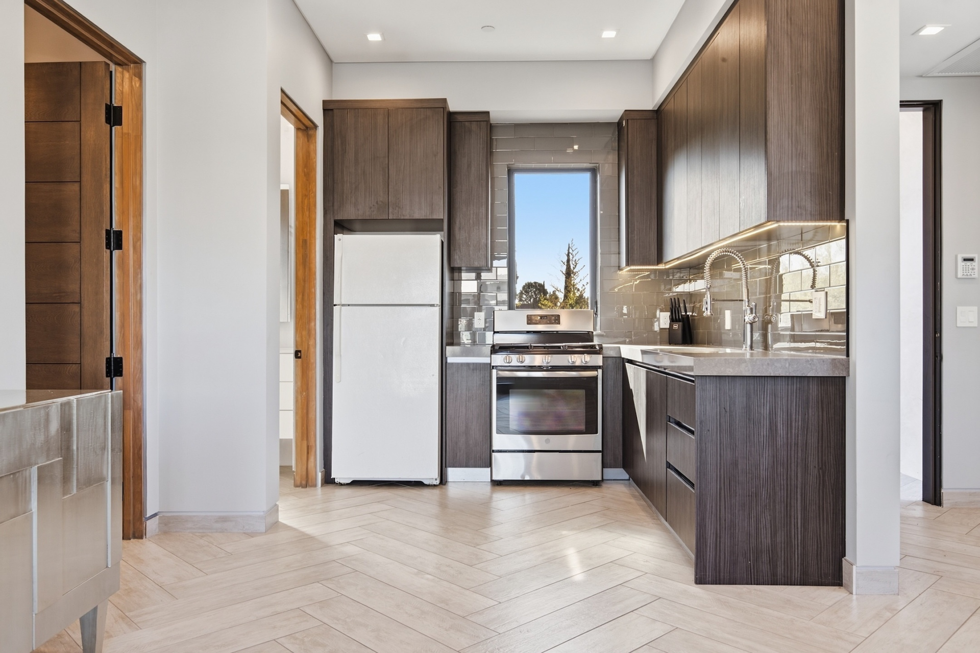 A compact kitchen is tucked into one side of the room.